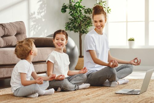 Family incorporating virtual speech therapy in NYC into daily routines, practicing movement and mindfulness together at home.