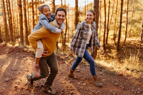 Family with small child hiking outdoors in autumn nature