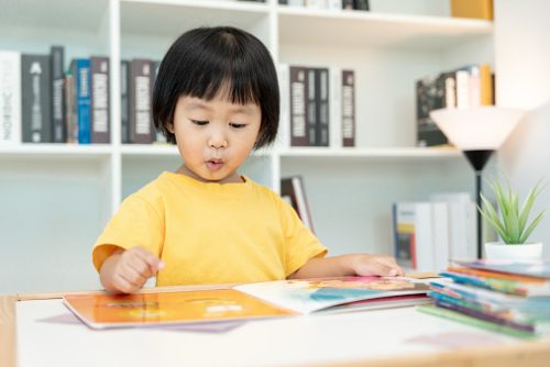Happy Asian children relax read book at home. daughter and reading a story. learn development, childcare, laughing, education, storytelling, practice, imagine, reduce addiction mobile phone