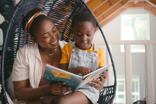 Book, story and mom reading to child for growth, development and learning with knowledge for kid. Apartment, mother and daughter relax in home for literature, fairytale and fantasy for family