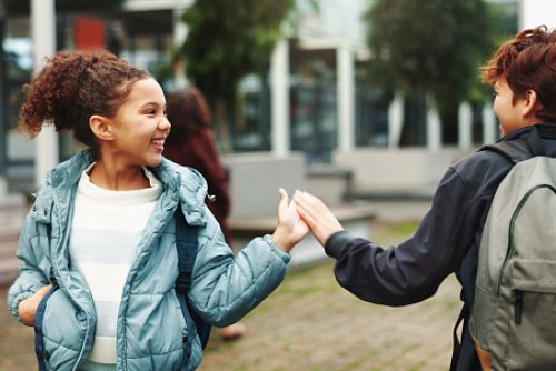 Children, handshake and happy with greeting at school, start and excited for learning in morning. Kids, friends and shake hands for education, development and scholarship with kindness at academy