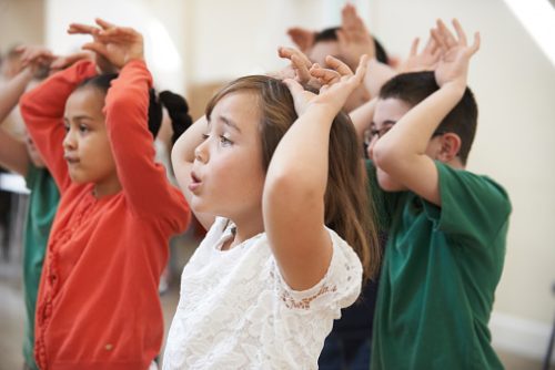Children participating in group play together, representing peer engagement and communication skills fostered in speech therapy for autistic children in NYC.